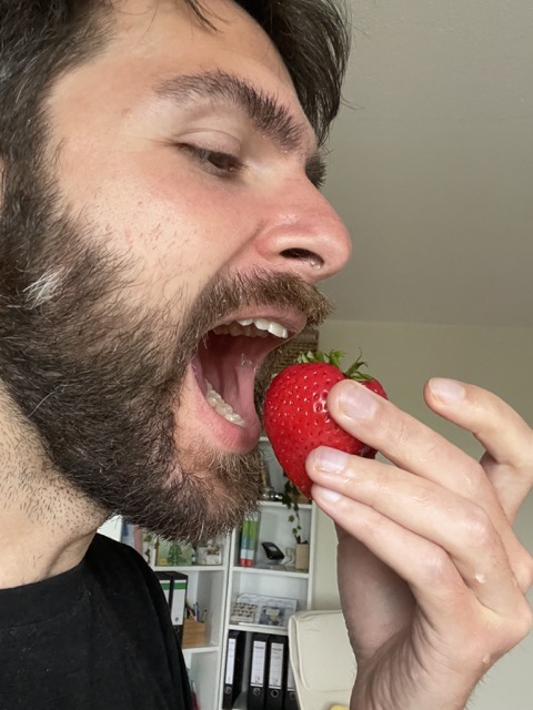 Alexander Fufaev eating strawberry stem with