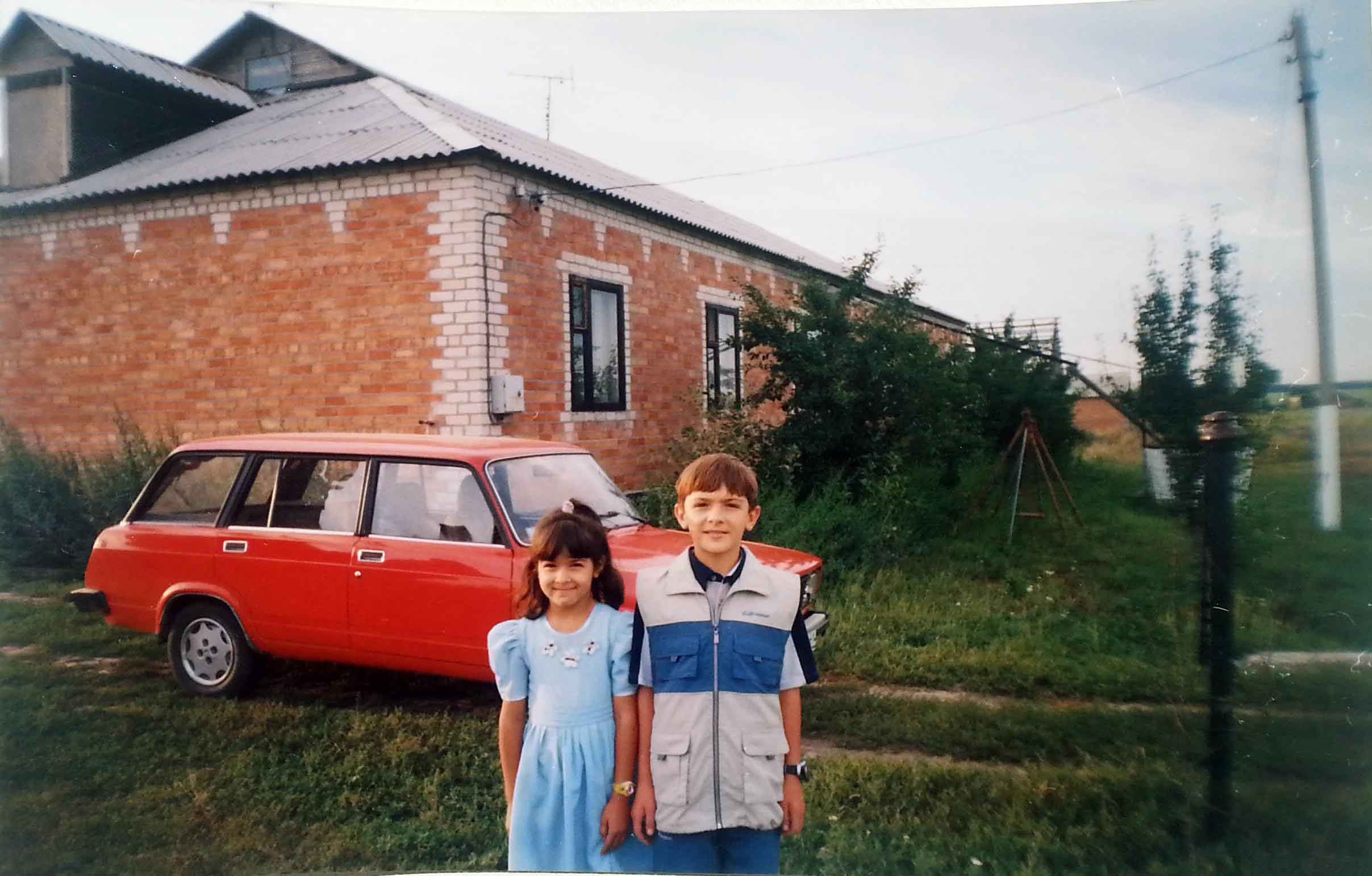 Alexander Fufaev and his sister in front of their grandparents' house in Kharkovskiy